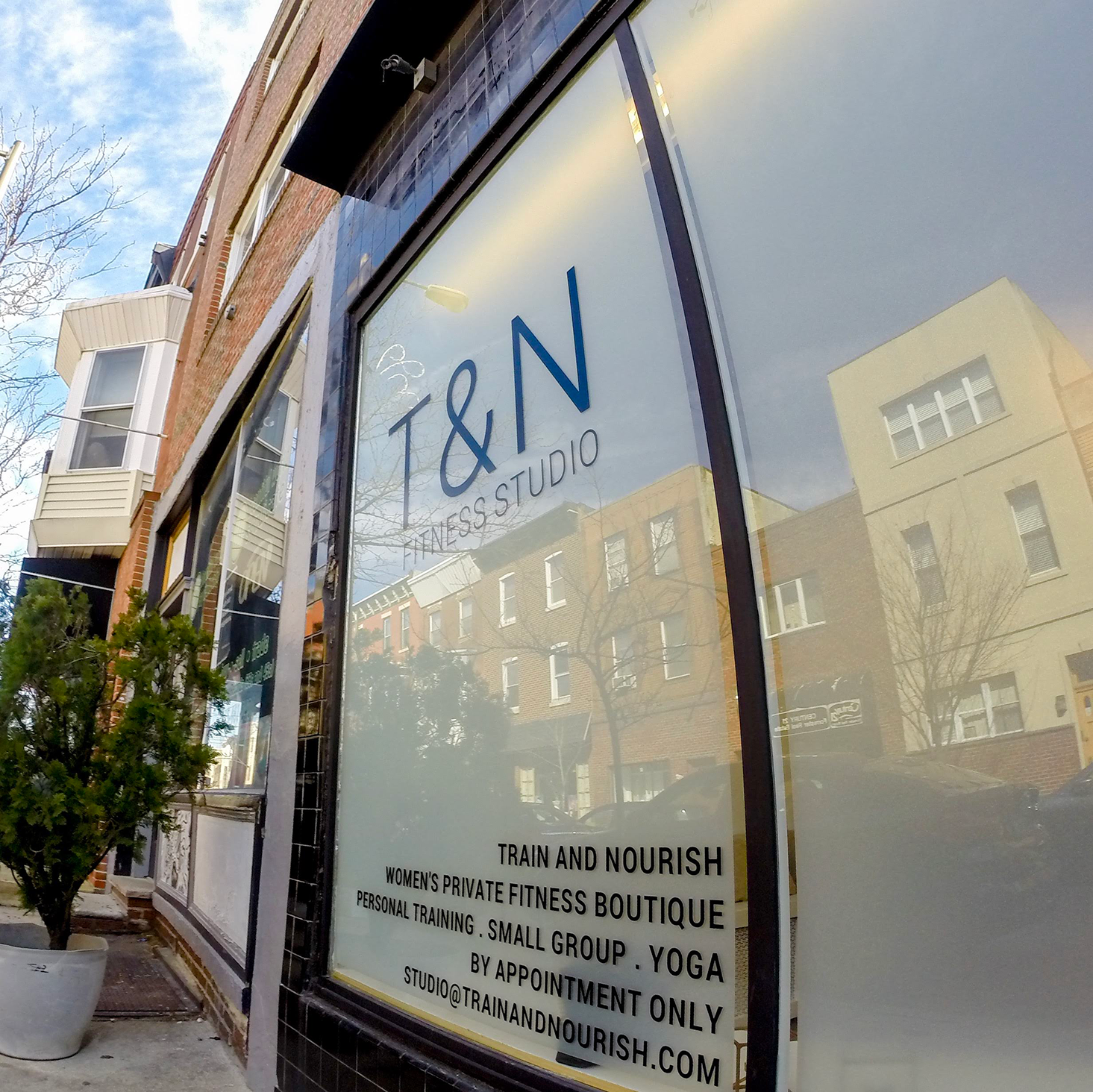 T & n boutique on the corner of a street, offering women's fitness apparel in Philadelphia.