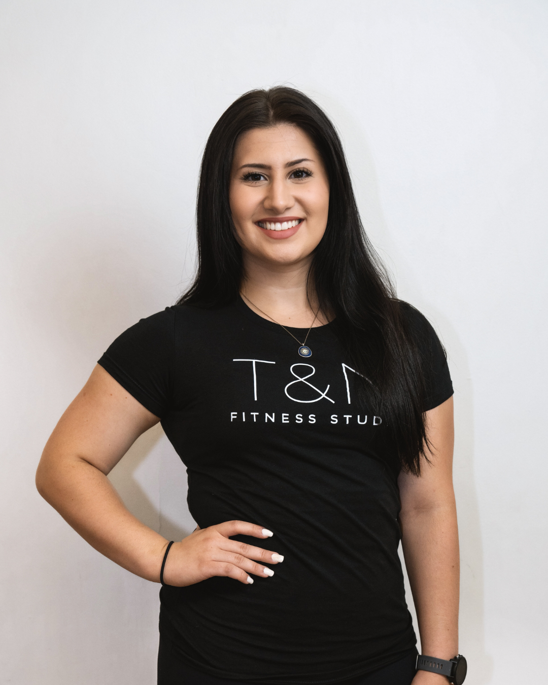 A woman wearing a black t-shirt representing the team of T&N Fitness Studio.